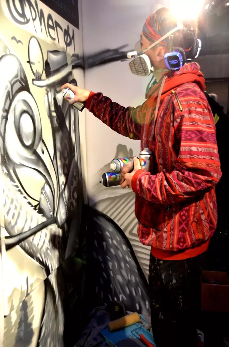 Pher01 paints a mural at Artopia 2017. - LINDSEY BARTLETT