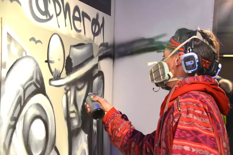 Pher01 paints a mural at Artopia 2017. - LINDSEY BARTLETT