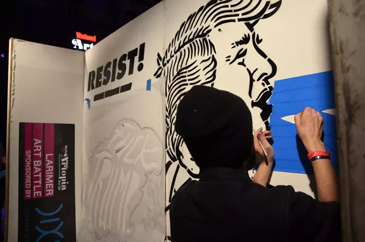 Scot Lefavor paints a political mural at Artopia 2017. - LINDSEY BARTLETT