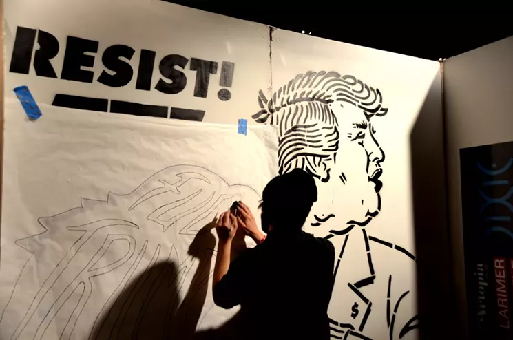Scot Lefavor paints a mural at Artopia 2017. - LINDSEY BARTLETT