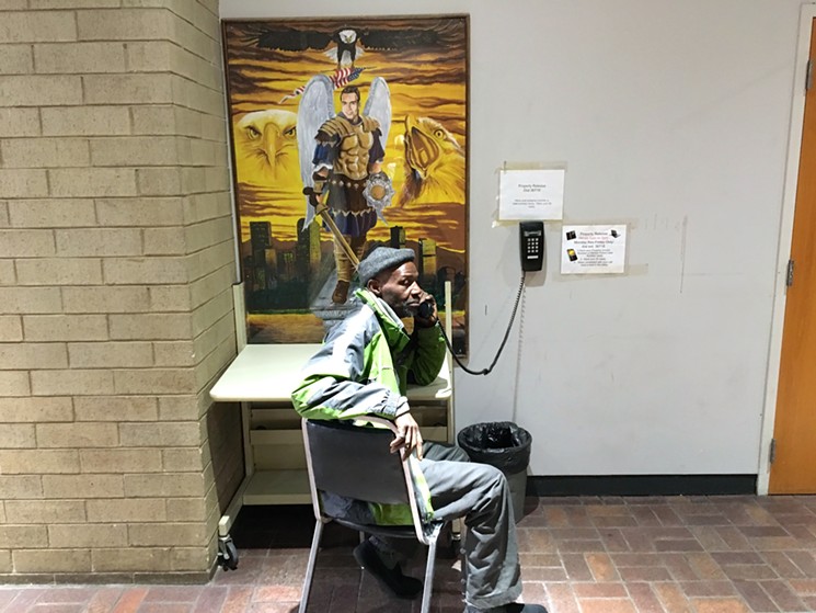 Anyone seeking to repossess their items from DPD must speak to an attendant through a wall-mounted phone next to a painting inside the headquarters lobby - CHRIS WALKER