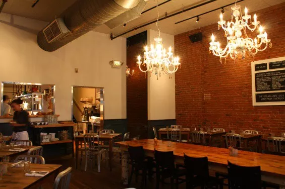 The community table at the Kitchen, where you can join your neighbors for Community Night. - BRITT CHESTER