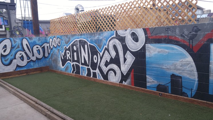 The bocce ball court on the back patio at the Matchbox has an ever-changing artistic backdrop. - SARAH MCGILL