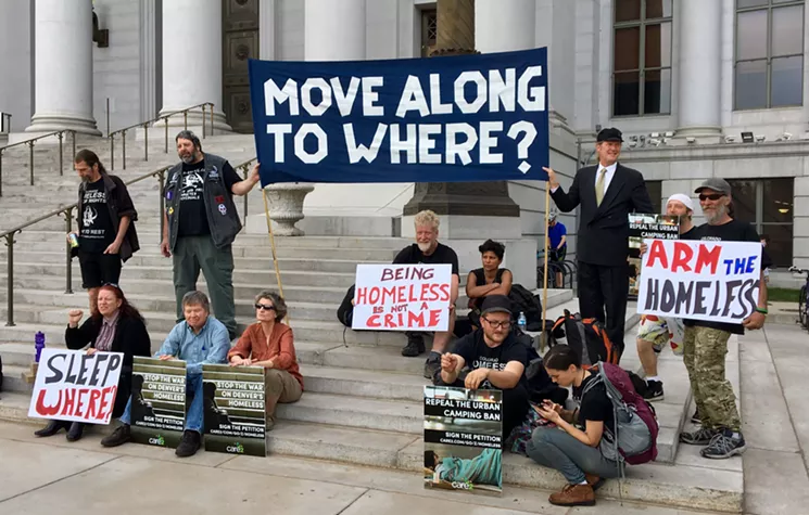 Demonstrators gathered outside of the City and County Building before the City Council meeting. - CHRIS WALKER