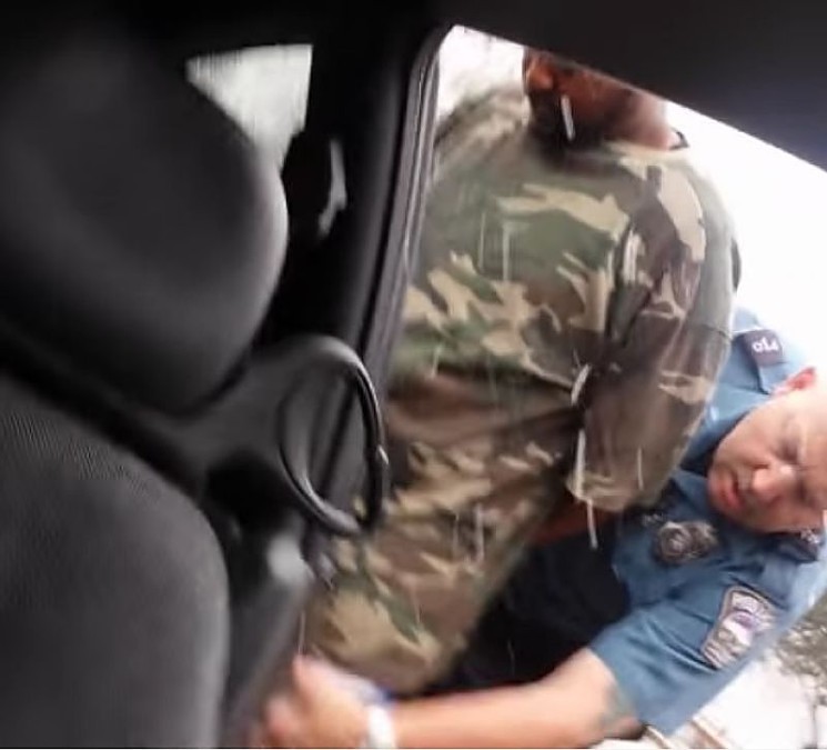 Benjamin Brown being searched by Officer Nelson. - YOUTUBE FILE PHOTO