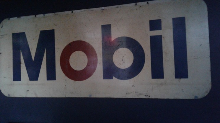 This Mobil sign is one of the collection of antique signs and other automobile-related decorations at the Garage. - SARAH MCGILL