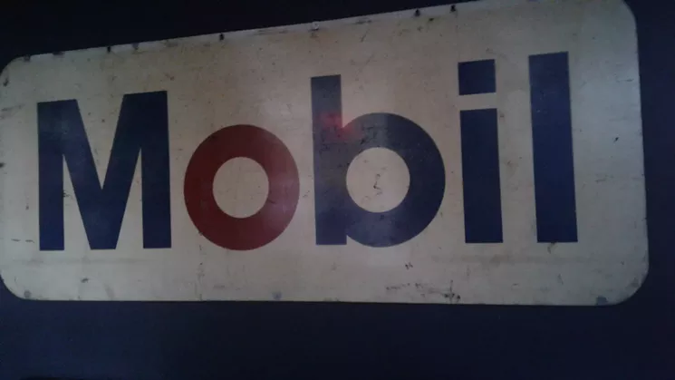 This Mobil sign is one of the collection of antique signs and other automobile-related decorations at the Garage. - SARAH MCGILL