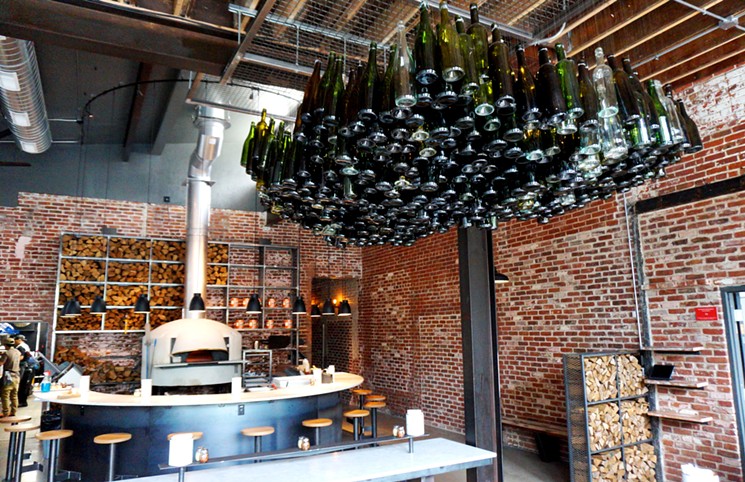 A wood-fired oven and a few hundred wine bottles are all that's needed for decor at White Pie. - MARK ANTONATION