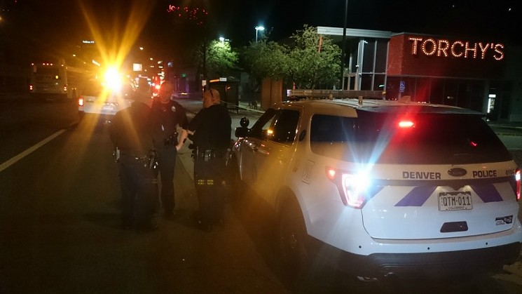 Officers assigned to the investigation near Torchy's Tacos. - PHOTO BY MICHAEL ROBERTS