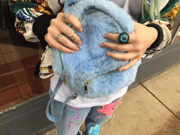 MayG's backpack is made of blue faux-fur, her favorite color and the color of her hair. - PHOTO BY MAURICIO ROCHA