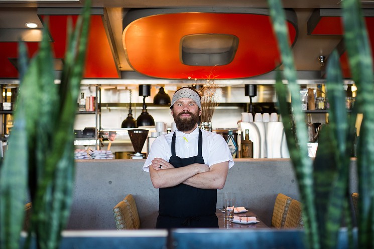 Chef Jesse Vega — and the "Hot" sign behind him — will still be there when Central Bistro reopens as Candela Latin Kitchen. - DANIELLE LIRETTE