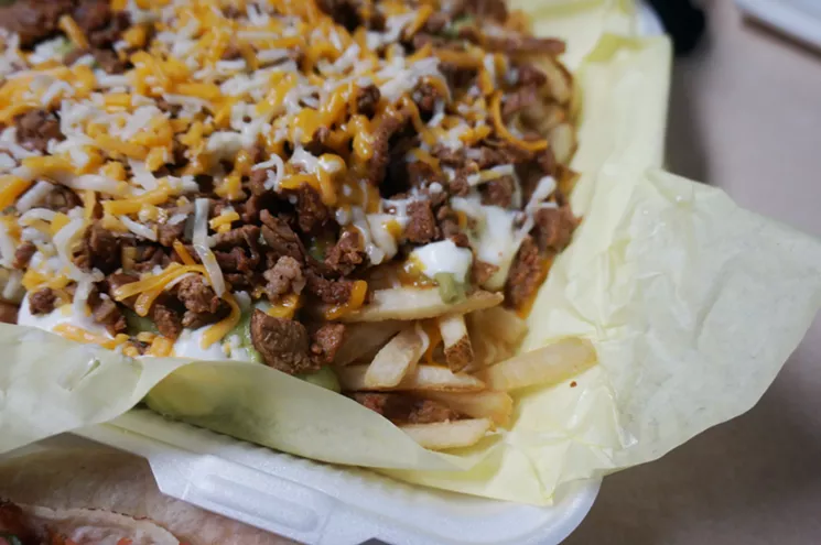 Carne asada fries are big at Tacos Los Compas. - MARK ANTONATION