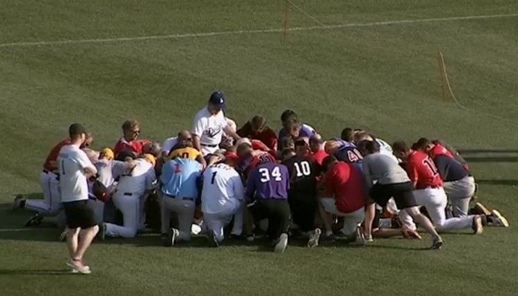 Players for Republicans and Democrats gathered at second base for a moment of silent prayer before the game got under way. - YOUTUBE