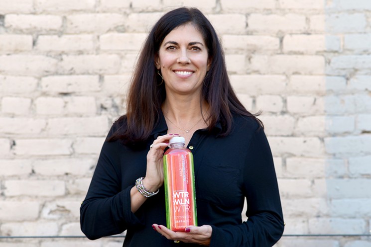 CEO and Coloradan Christine Perich holds up a bottle of WTRMLN WTR. - WTRMLN WTR