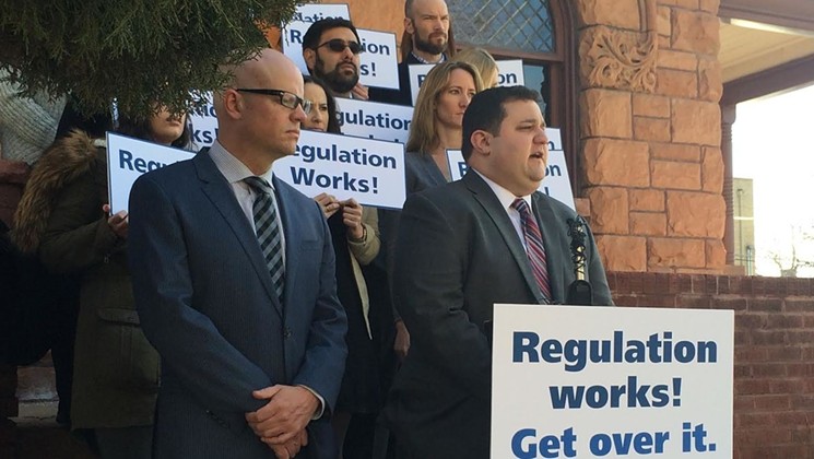Tvert at a 2015 protest. In the foreground on the left is VS Strategies principal Christian Sederberg, while his cohort, Brian Vicente is in the background at the top right. - COURTESY OF THE MARIJUANA POLICY PROJECT