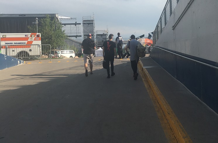 3LAU (middle) walking from the tunnel at Mile High Stadium to the main stage at Global Dance Festival. - DYLAN WHITE