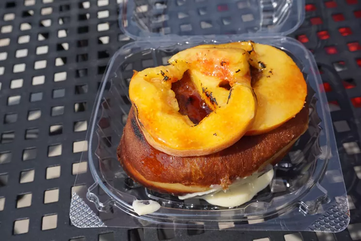Glazed and Confuzed's peaches and cream doughnuts are topped with fresh peach sllices. - VERONICA PENNEY