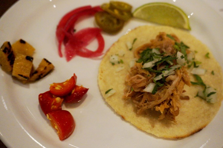 Pig-head carnitas taco with topping options — charred pineapple, pickled onion, pickled jalapeño and sweet-hot chiles — at El Jefe. - MARK ANTONATION