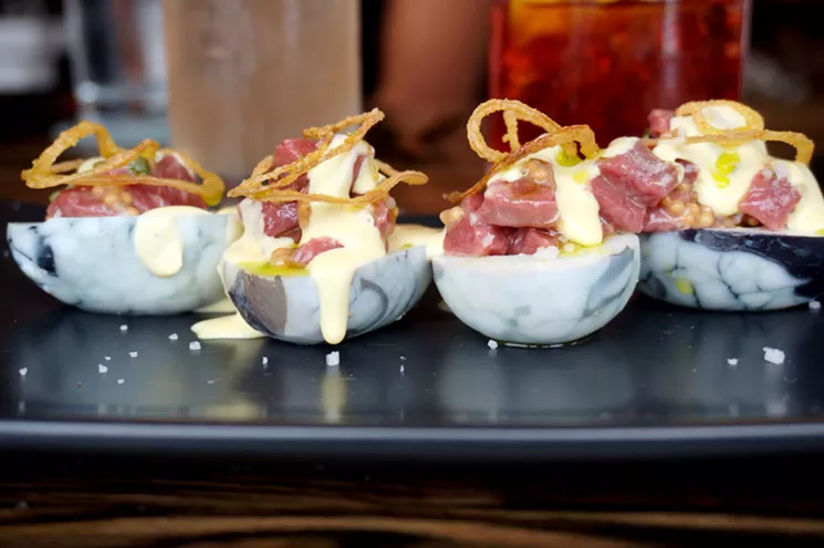 Bar Helix's "devilish" eggs come stuffed with Western Daughters dry-aged sirloin tartare and are marbled with a red-wine brine. - MARK ANTONATION