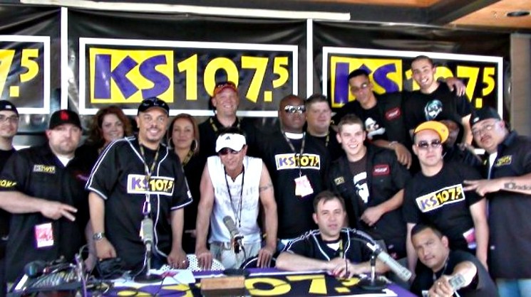The KS-107.5 crew circa 2008. Kendall B is standing by the microphone to the left, while Kathie J is over his right shoulder and Larry Ulibarri is seated with his arms on the table. - FACEBOOK