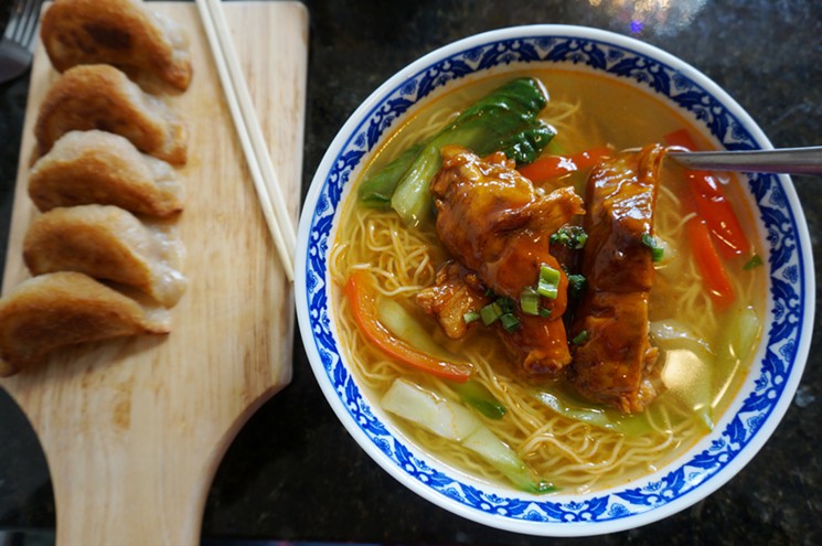 Egg-noodle soup with pork ribs and a side of beef-filled dumplings. - MARK ANTONATION