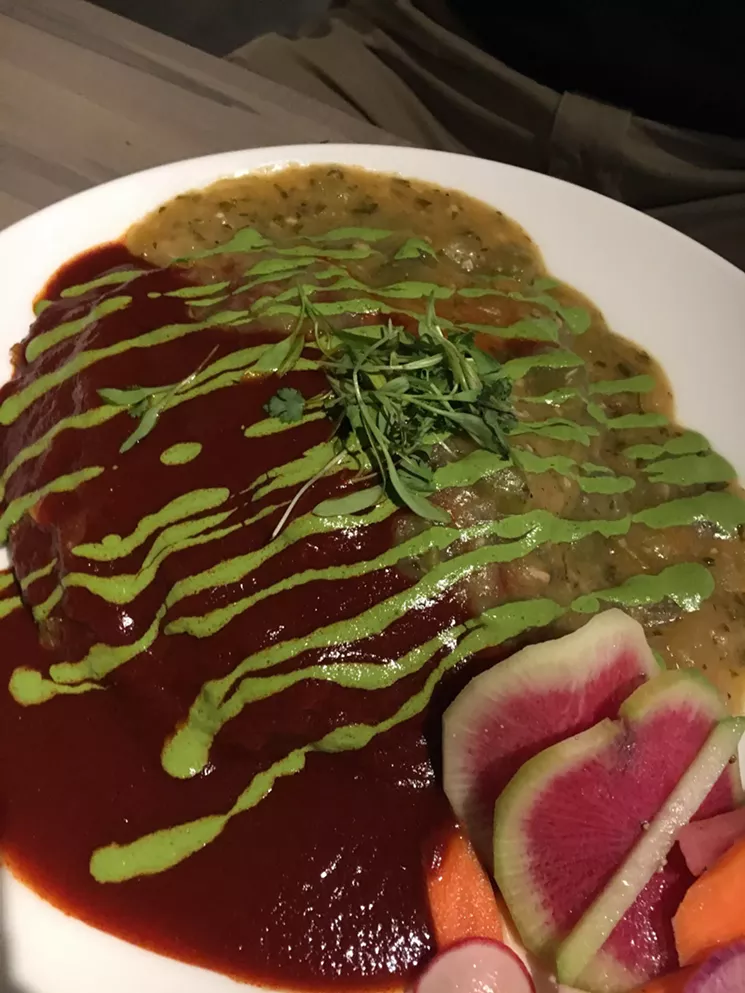 Merry Christmas from Santo in Boulder. Not even an edge of the stacked enchiladas peeks out from beneath red and green chiles. - MARK ANTONATION