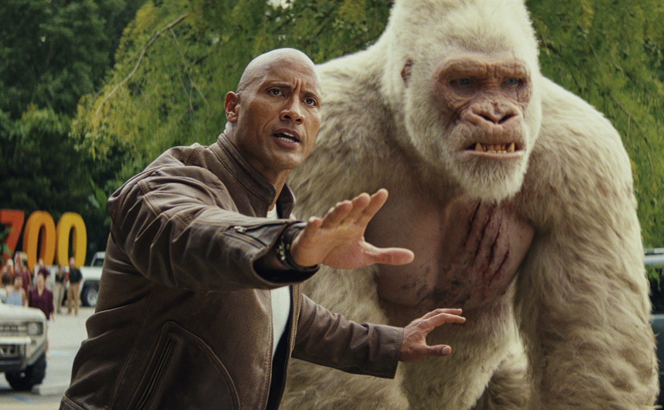 Dwayne Johnson plays Davis, a misanthropic Special Forces soldier-turned-primatologist who trades solemn fist-bumps and sign-language dirty jokes with George, an ape that turns into a giant monster, in Rampage.