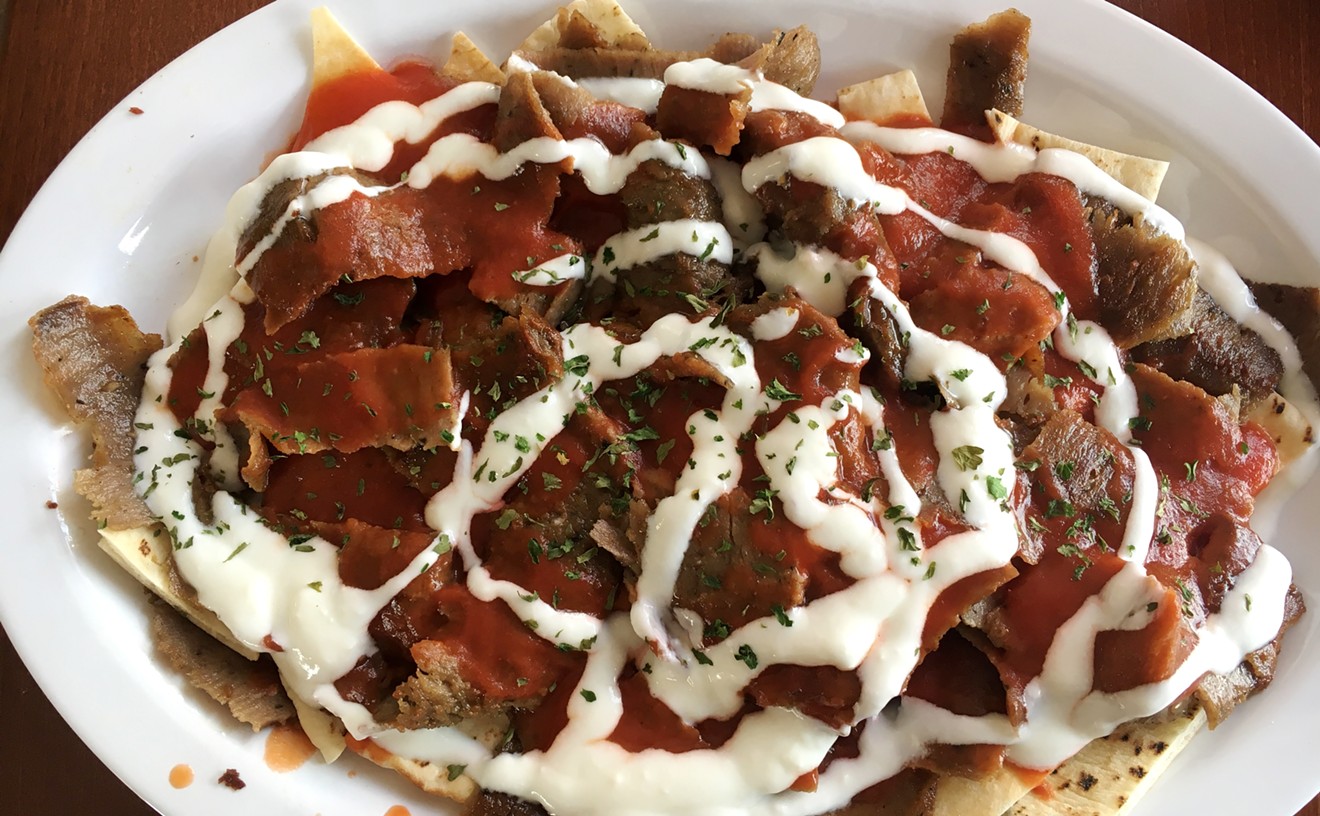 Iskender kebab is a traditional Turkish dish served with tomato sauce and yogurt.