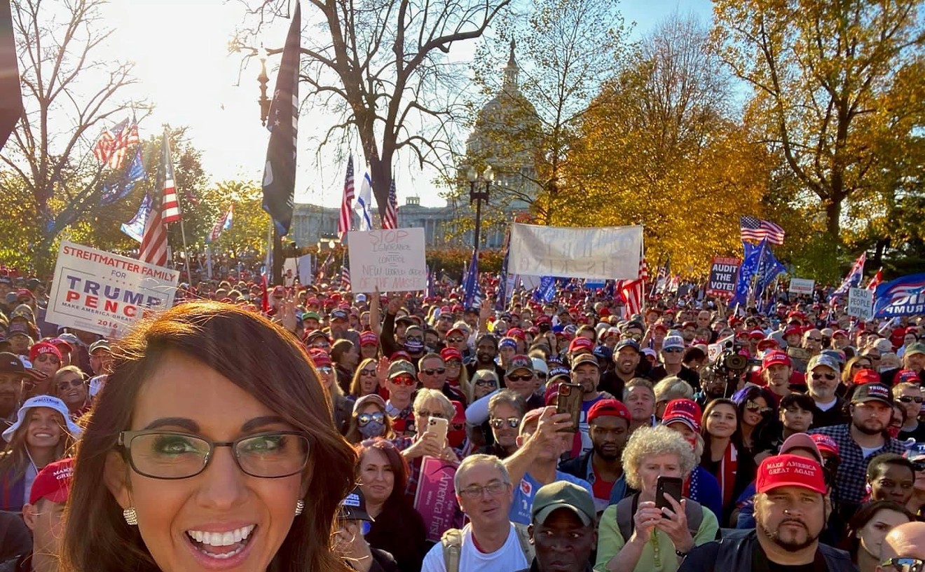 The MillionMAGAMarch summed up in one tweeted photo: Lauren Boebert in front of a sole Black guy who looks like he's just realized where he's standing.