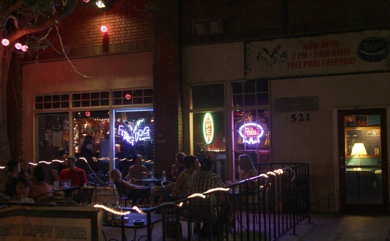 The small concrete patio basks in the glow of neon beer signs at Tooey's Off Colfax.