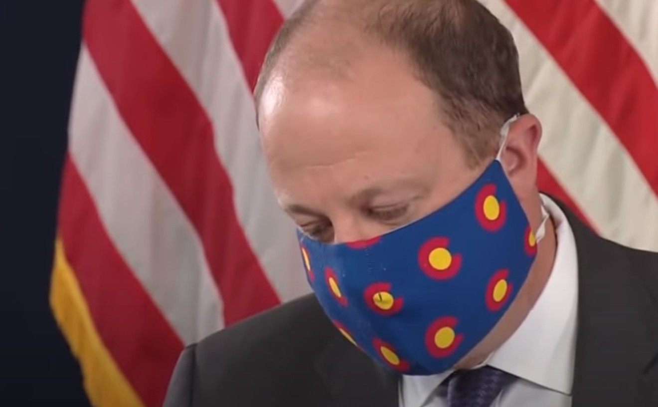 A masked Governor Jared Polis.