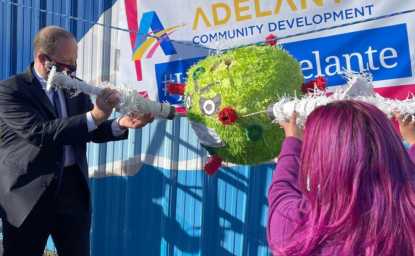 At a February 26 vaccination event, Governor Jared Polis jammed a faux-hypodermic into an angry-looking COVID-19 piñata.