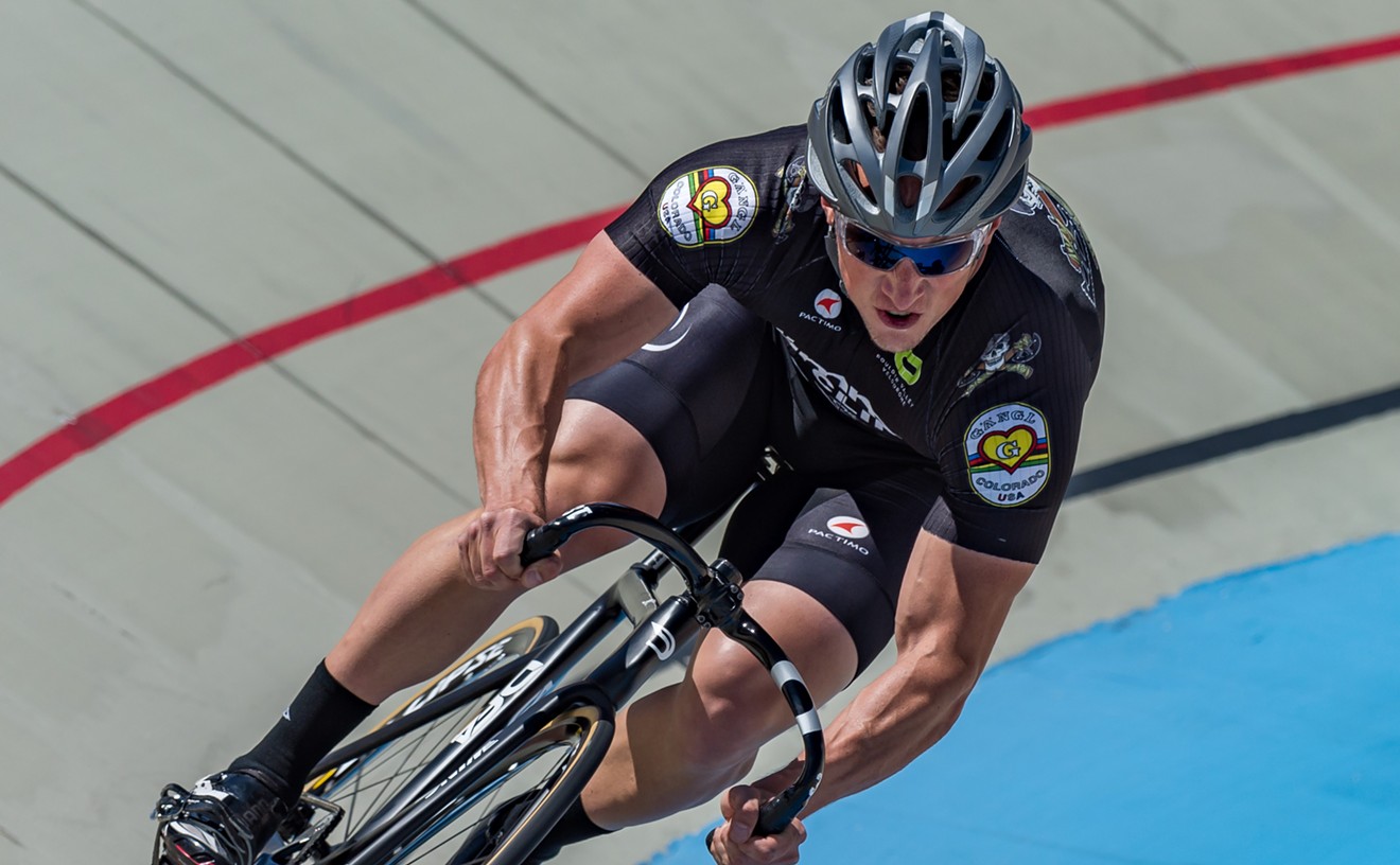 A cyclist leans on a banked turn in the Boulder Valley Velodrome.