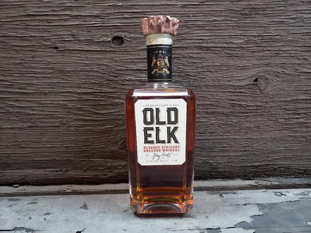 A bottle of Old Elk Blended Straight Bourbon Whiskey.