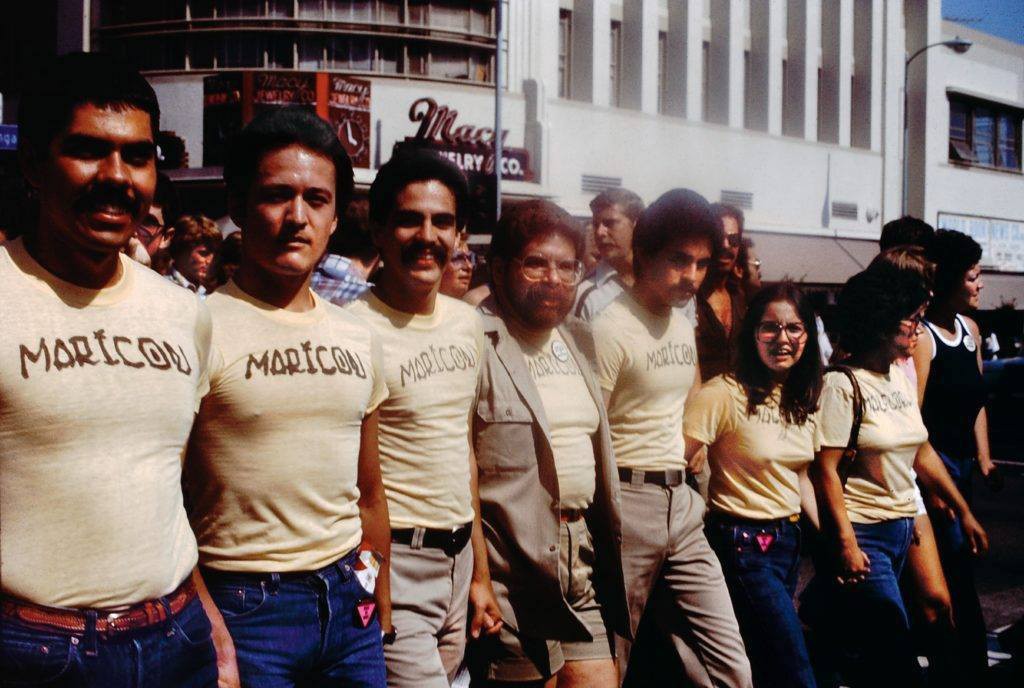 Participants in the Christopher Street West Pride parade wearing Joey Terrill’s malflora and maricón T-shirts, June 1976.