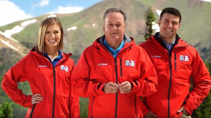 Channel 2 weather personalities modeling gear emblazoned with company logos.