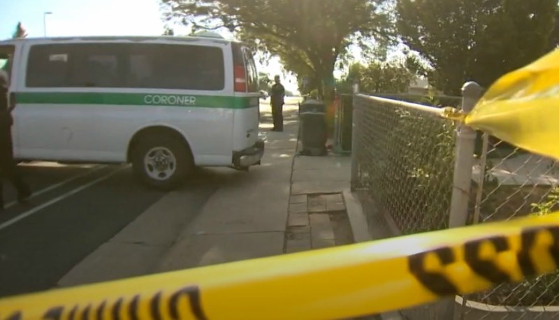 A coroner's van outside the Black residence the morning after the shooting.