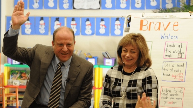 The landing page for Governor Jared Polis's website shows him with Lieutenant Governor Dianne Primavera on a school visit.