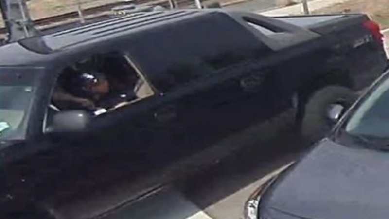 A surveillance image capturing a person of interest in a May 3 shooting; the victim's death was announced on May 13.
