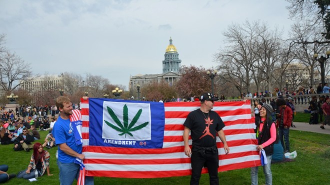 Cannabis protesters hold a marijuana flag in Civic Center Park