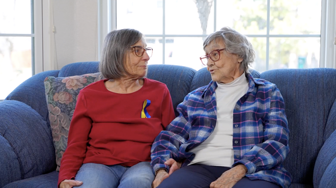 two elderly women speak with each other