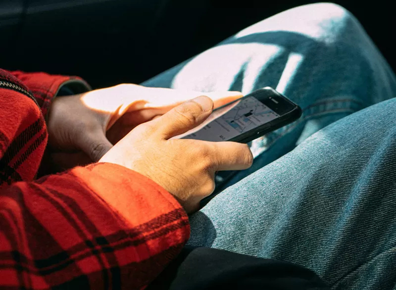 Image: person using uber app on phone