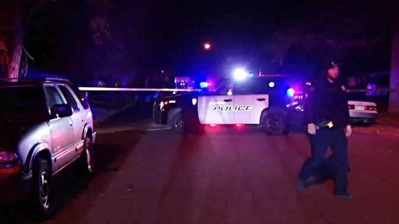 Image: An Aurora police officer on the scene of a quadruple homicide on October 30.
