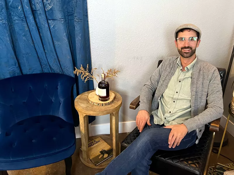 Image: a man sitting in a chair