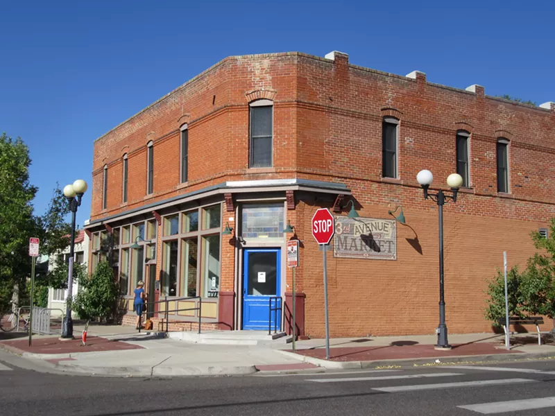 Image: The newly painted blue door of Under the Umbrella's Baker location.