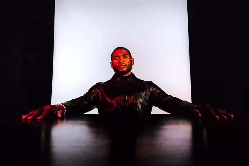 Image: usher sits at a table