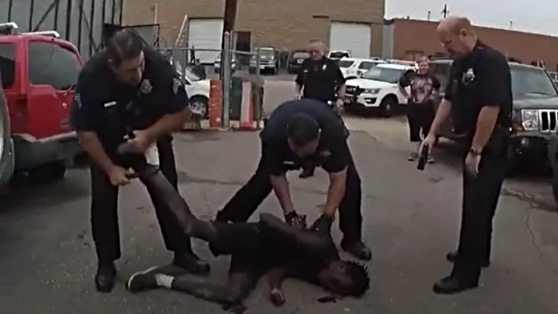 Image: Body-worn camera footage of Denver Police officers surrounding Malow Mayek, seventeen, on August 22, 2018.