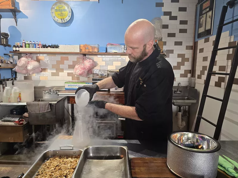 Image: man pouring liquid nitrogen into a bottle