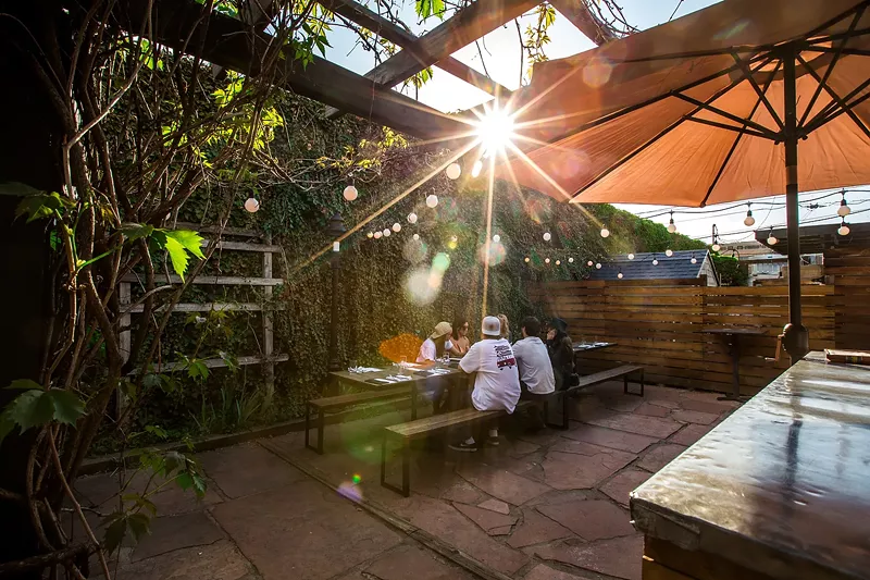Image: people sitting at a table on a patio
