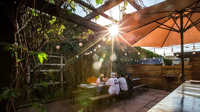 people sitting at a table on a patio